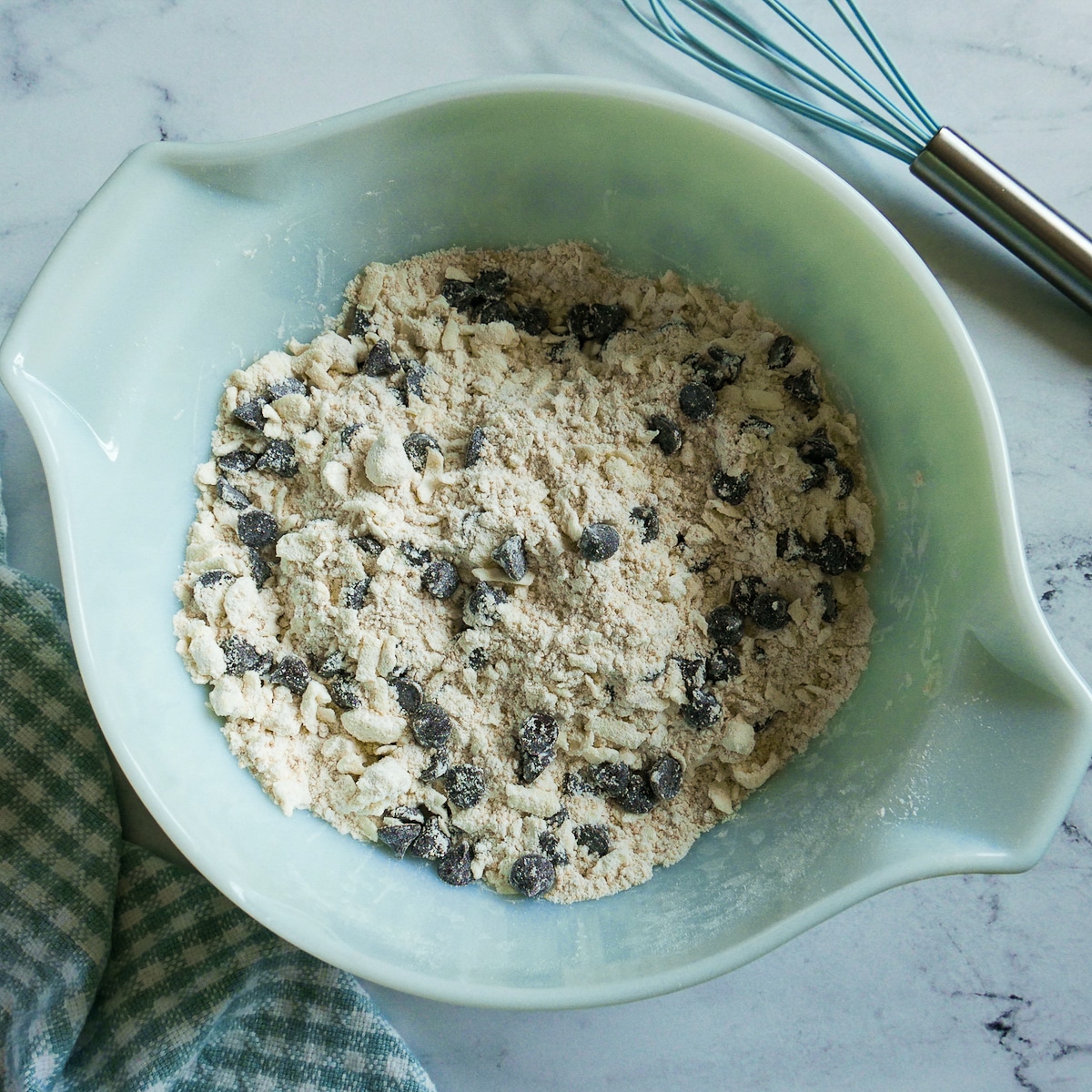 chocolate-chips-mixed-in.jpg chocolate chips stirred into flour and butter mixture.