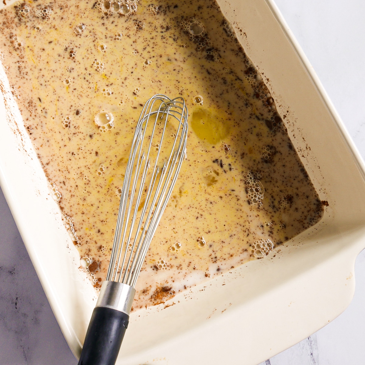 Liquid ingredients whisked together in a large baking dish.