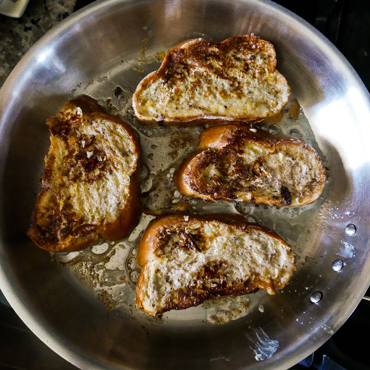 Frying French toast in a large skillet with butter.