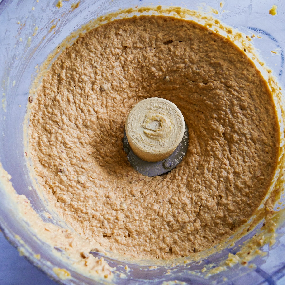 Hummus ingredients blended with ice cold water in a food processor.