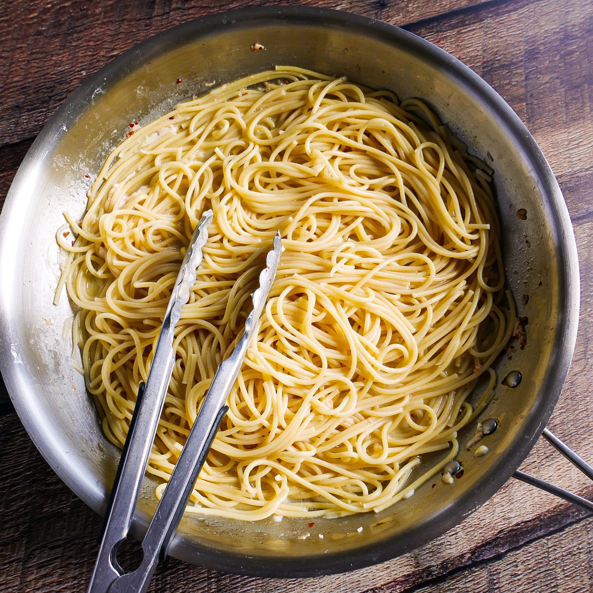 Cooked spaghetti noodles coated in sauce.