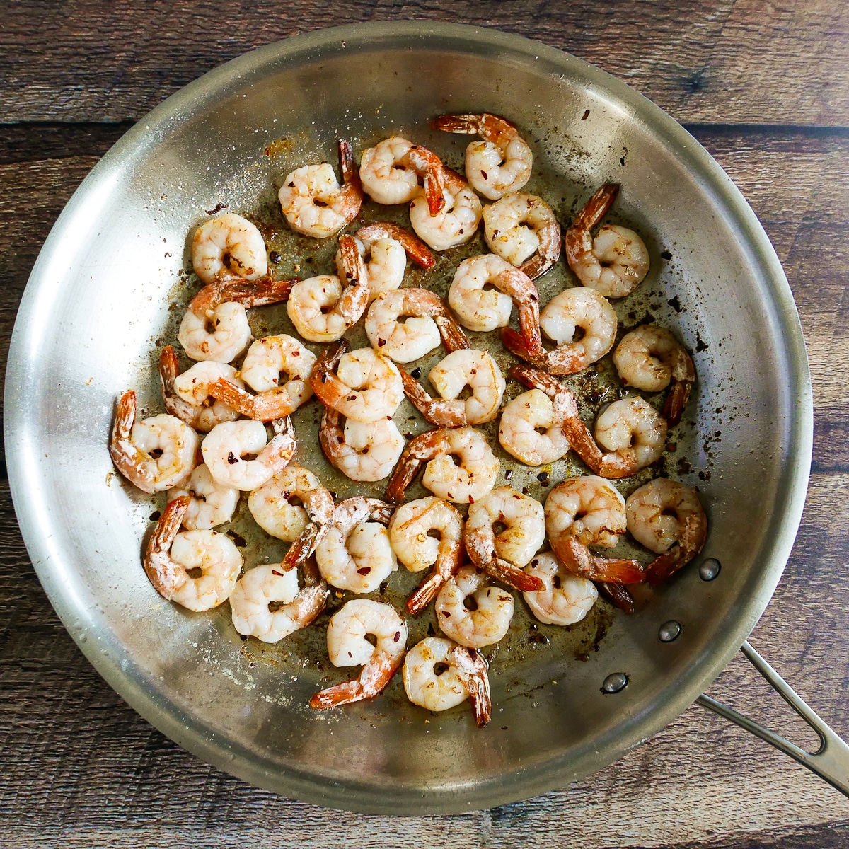 Cooking shrimp in butter and olive oil in a large skillet.