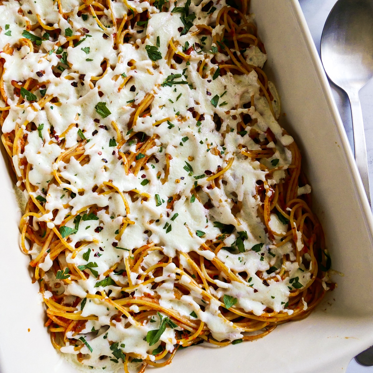 Melted and bubbly mozzarella cheese on top of leftover spaghetti bake.