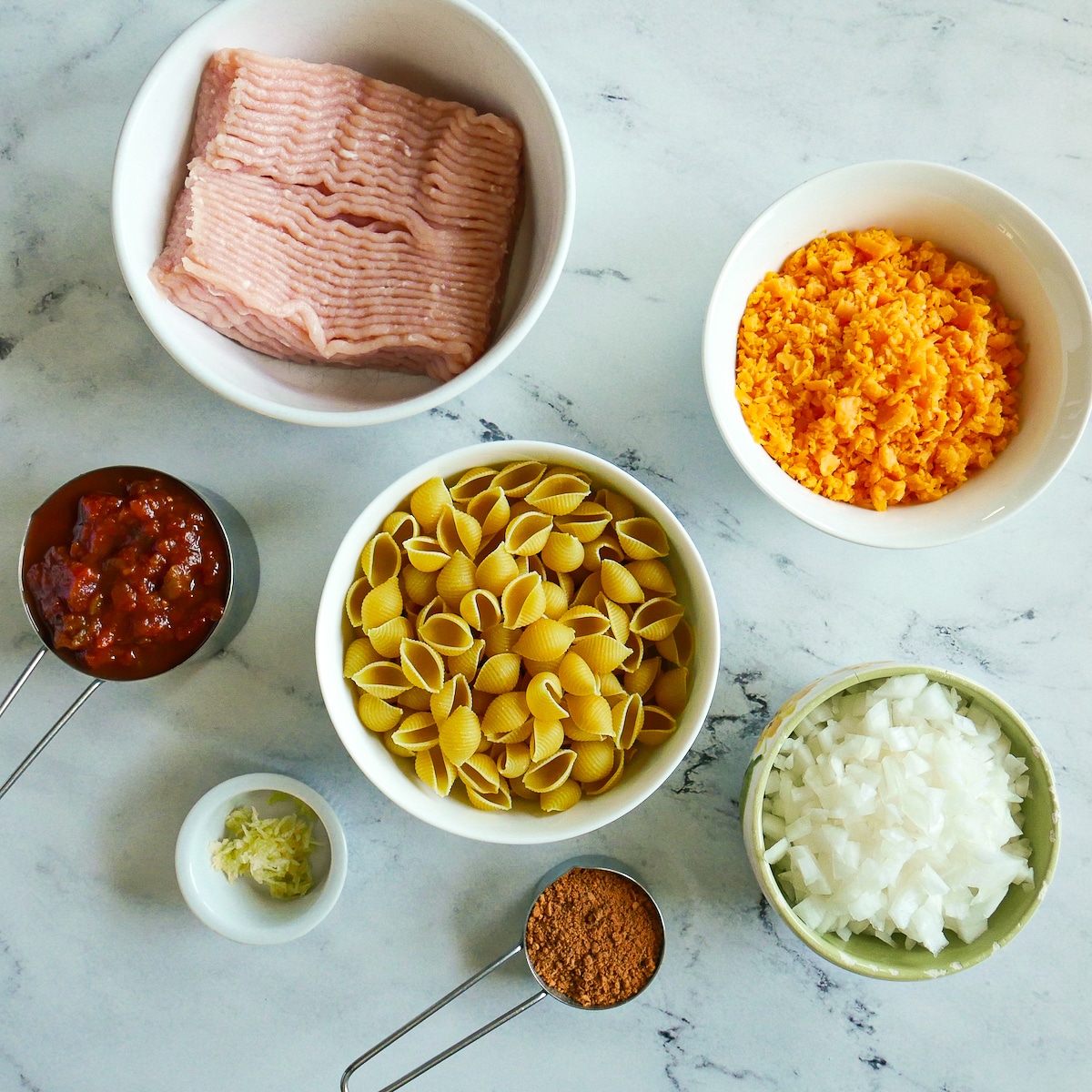 pasta-bake-ingredients.jpg pasta bake ingredients arranged on a table.