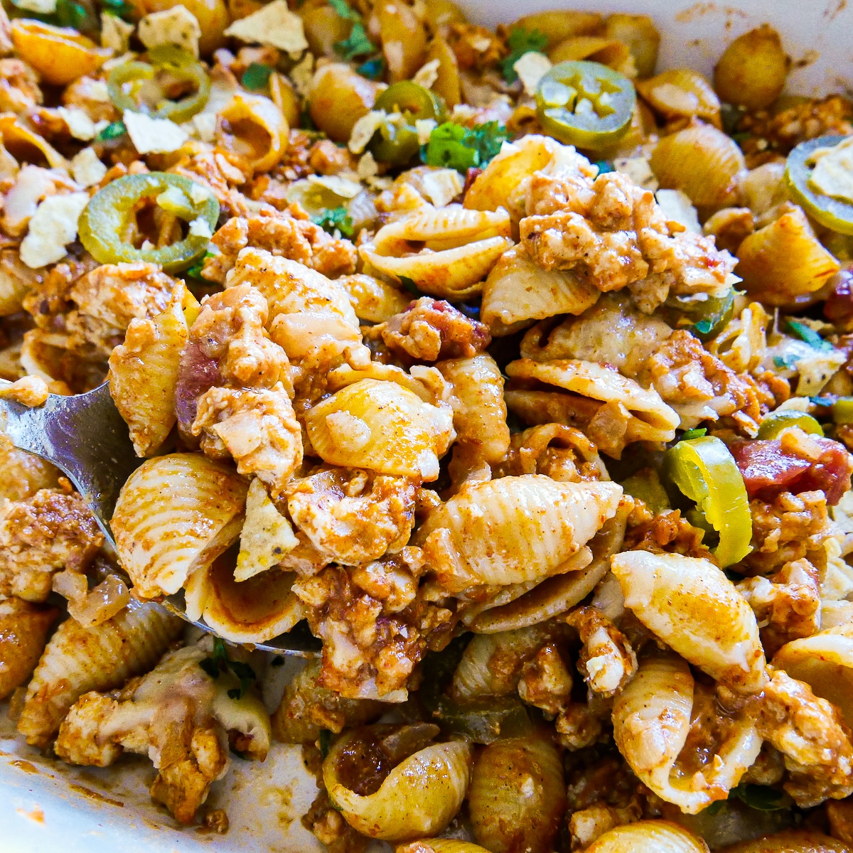 taco-pasta-casserole.jpg Large spoon scooping up taco pasta casserole from baking dish.