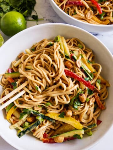 Bowl of easy peanut noodles with chopsticks.