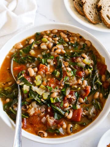 Bowl of healthy black eyed soup with a spoon.