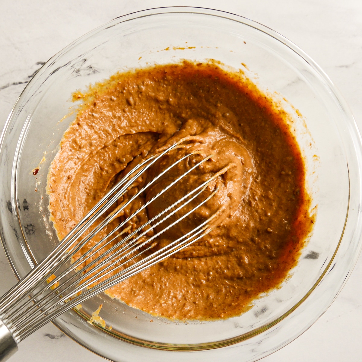 Wet ingredients whisked together in a medium bowl.