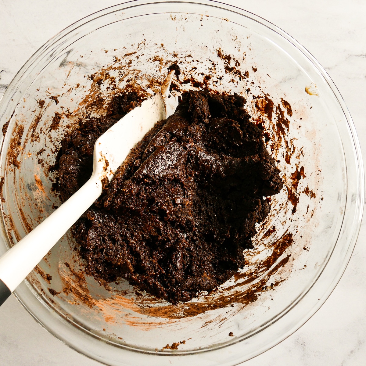 Wet ingredients mixed into dry ingredients with chocolate chips.