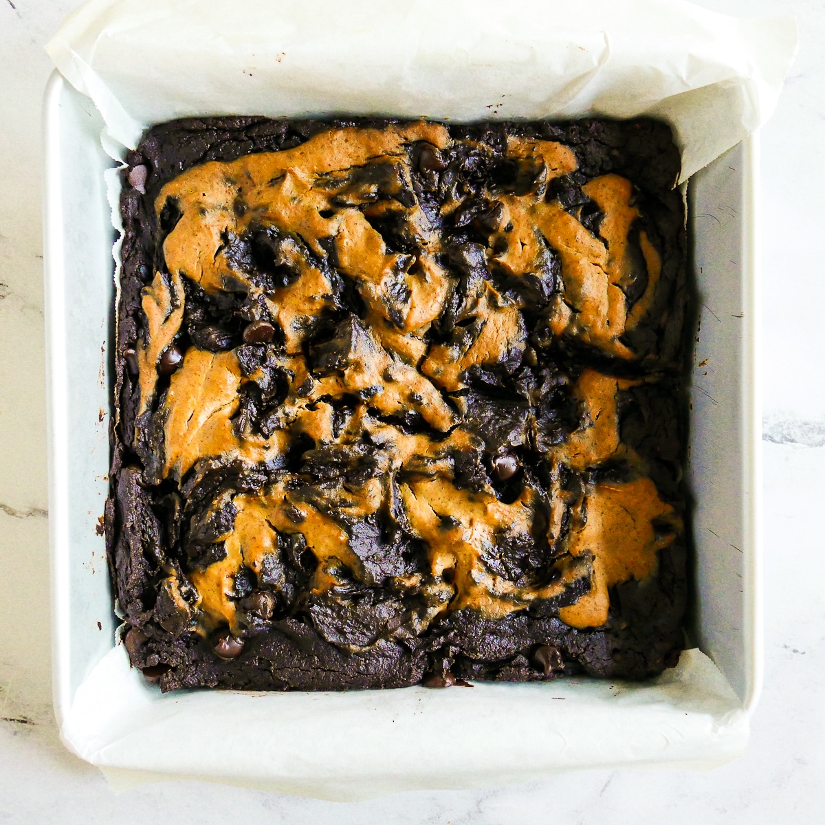 Baked brownies with pumpkin in a baking pan.