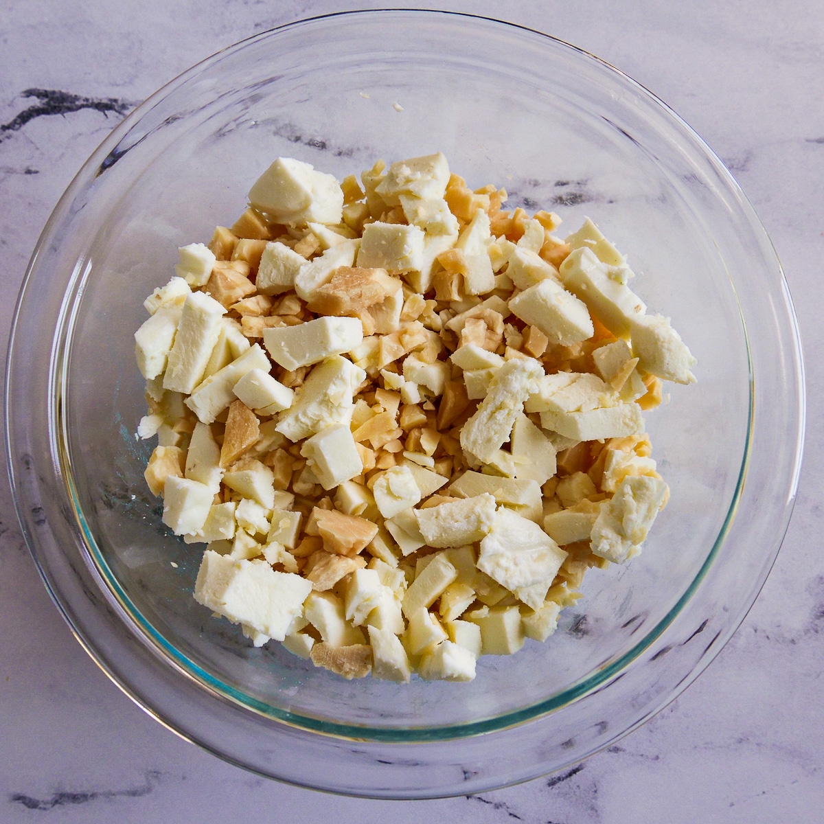 Shredded mozzarella and Parmesan cheese combined in a small bowl.