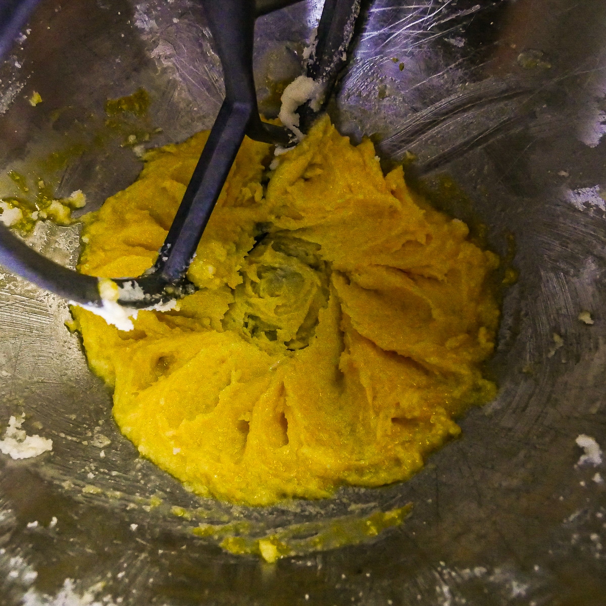 Beating in egg yolks to the butter and sugar mixture.