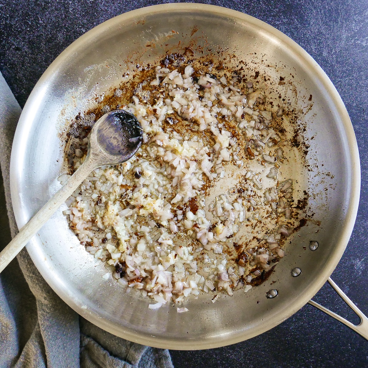 Diced shallots and garlic sauteing in butter in a large skillet.