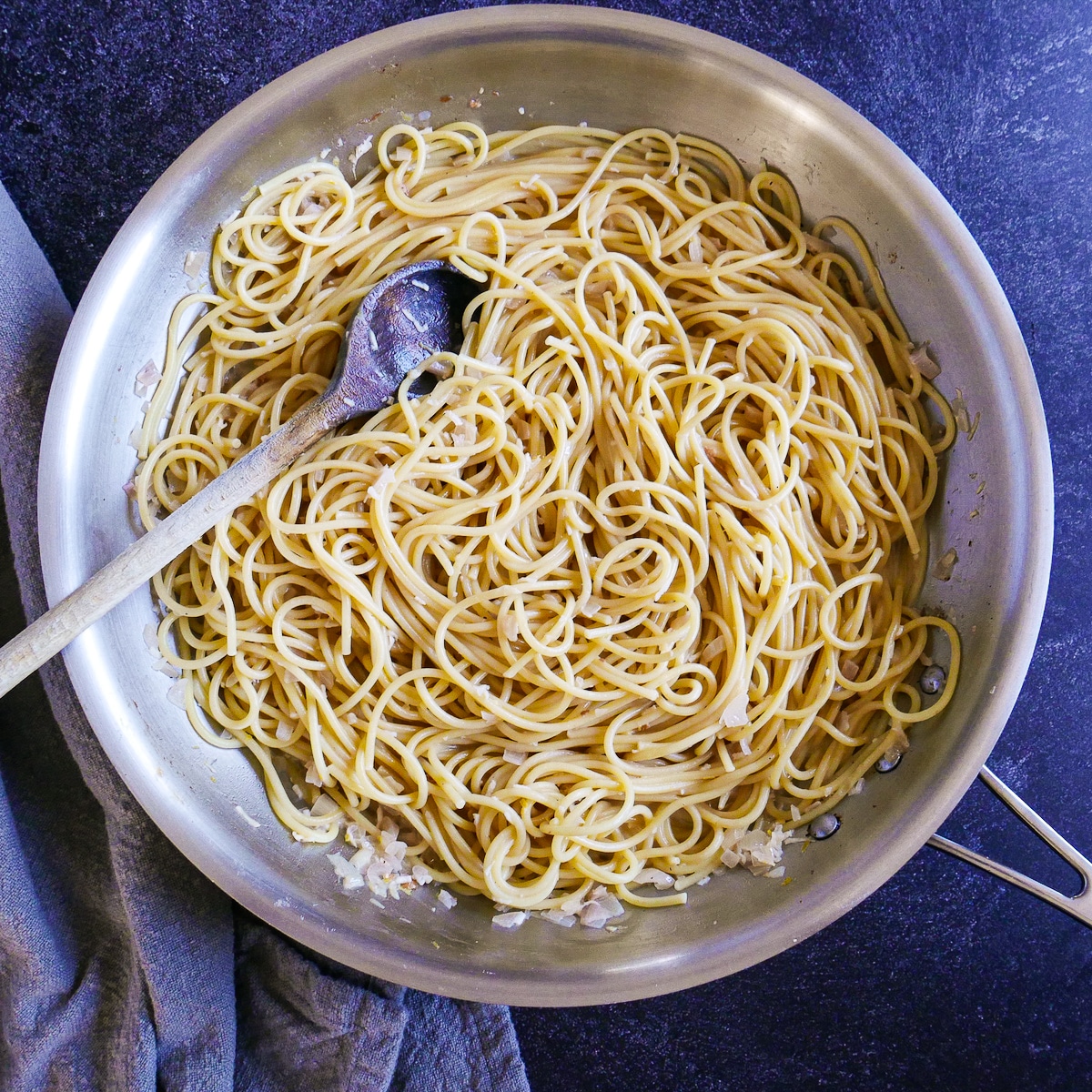 Cooked pasta added to pasta sauce.