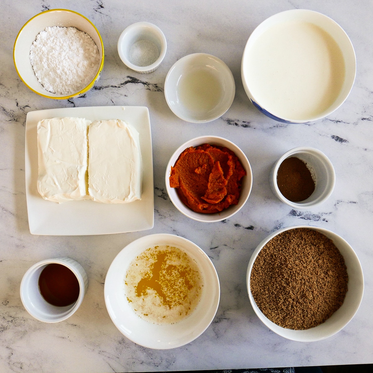 Ingredients for pumpkin bars arranged on a table.