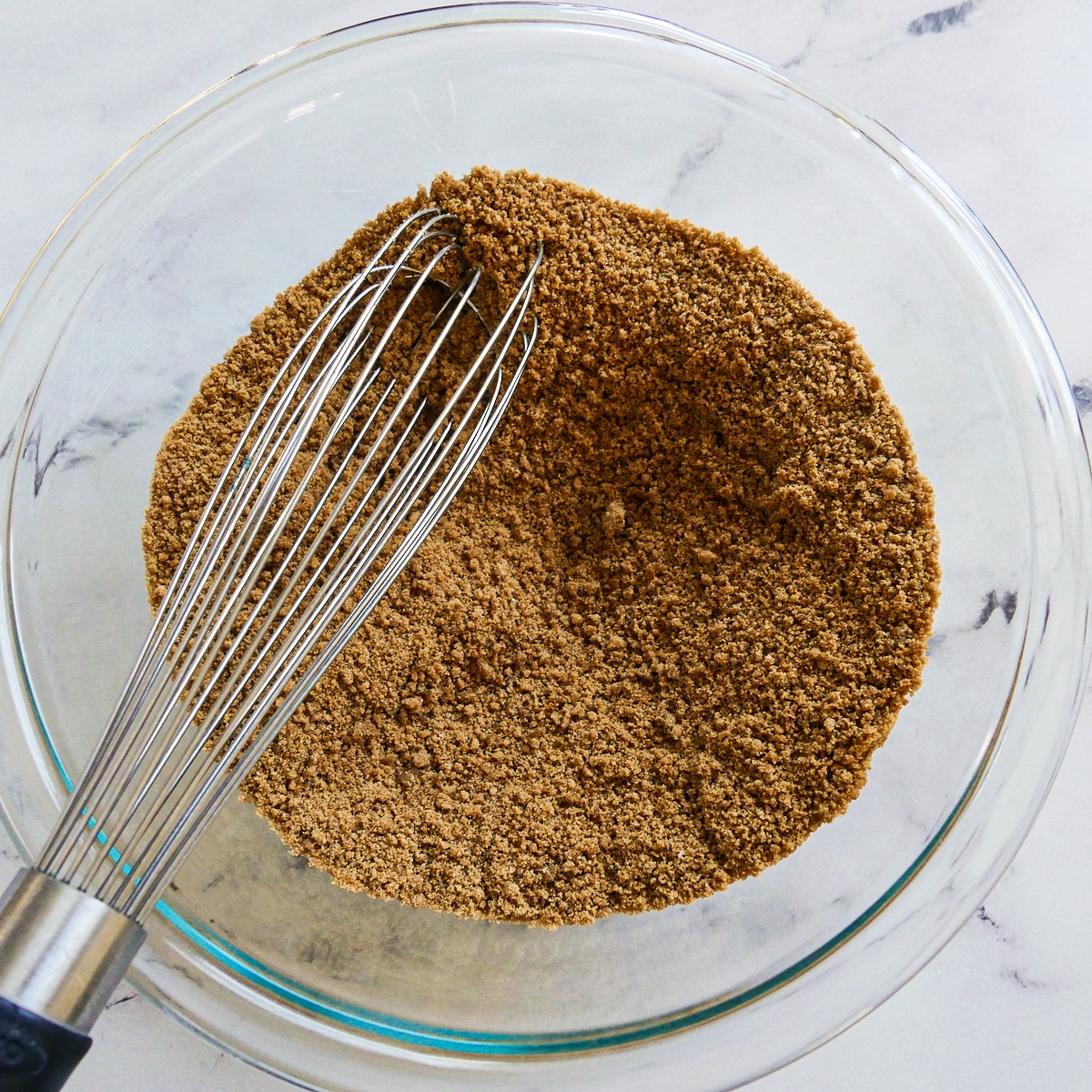 Crushed gingersnap cookies, salt, and brown sugar mixed in a bowl.