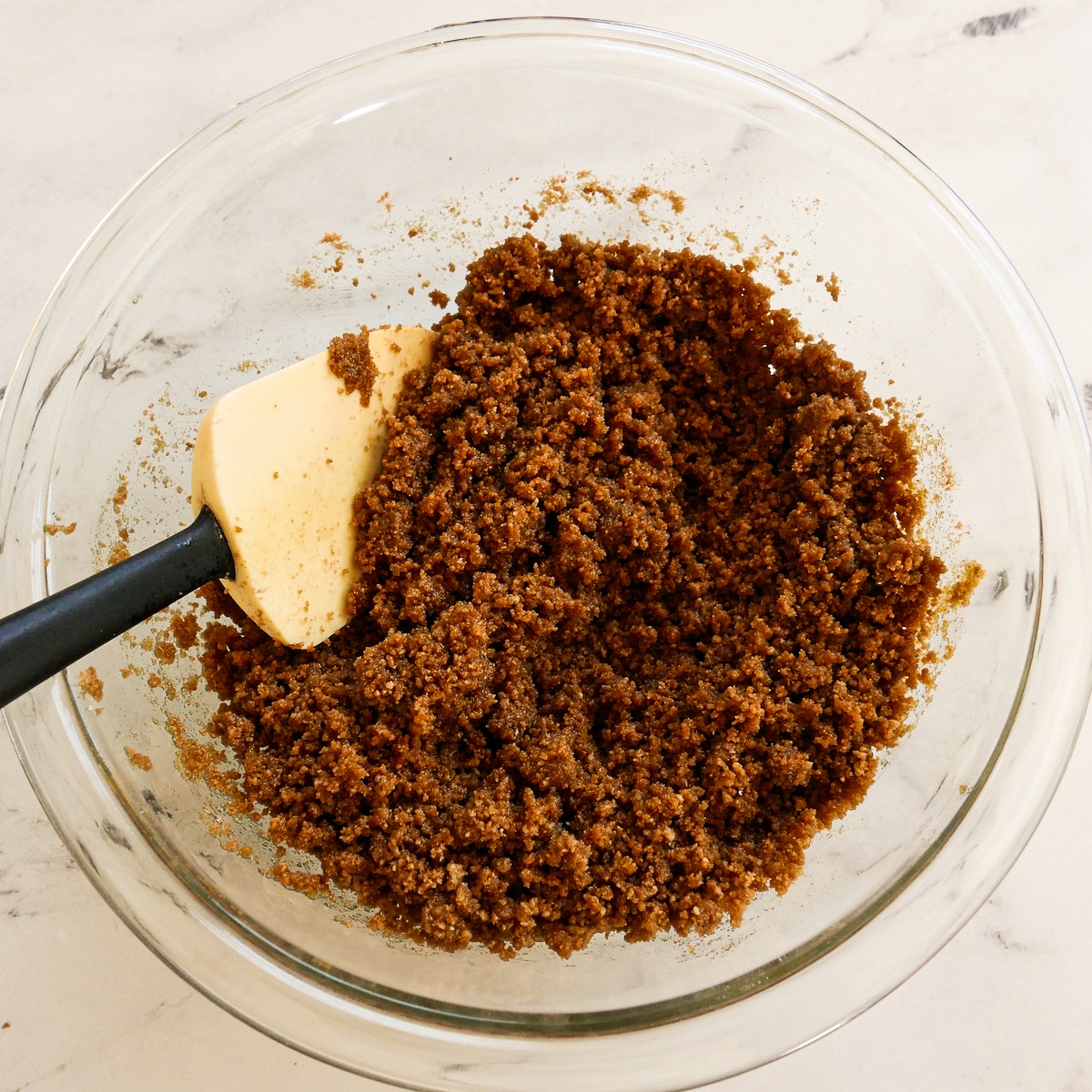 Melted butter added to gingersnap mixture in a large bowl.