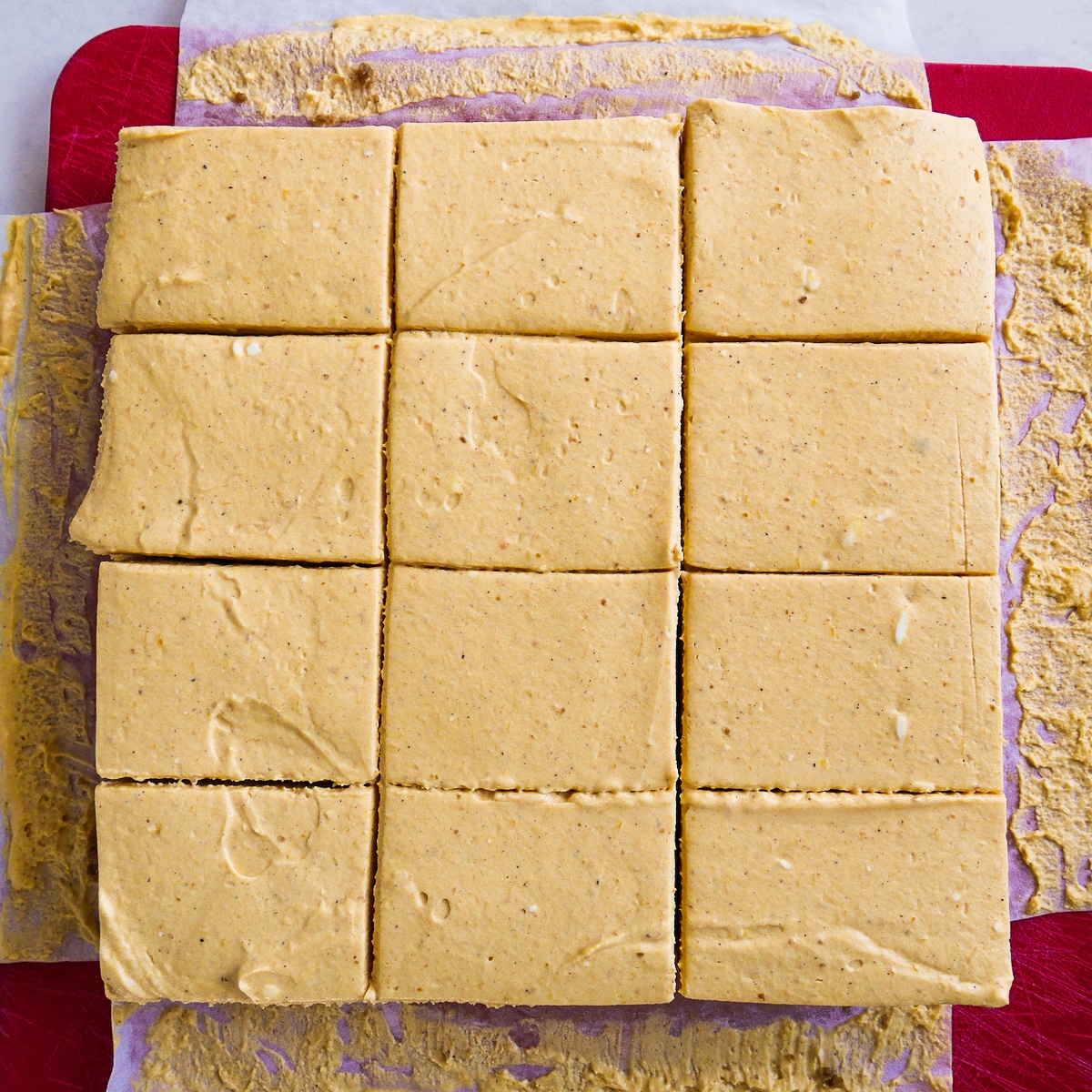 Pumpkin cheesecake bars cut cleanly into 12 slices.
