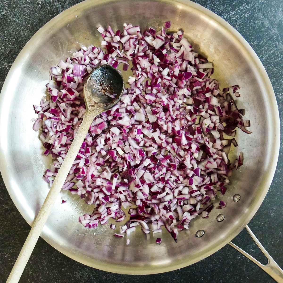 Sauteed red onion in a large skillet.