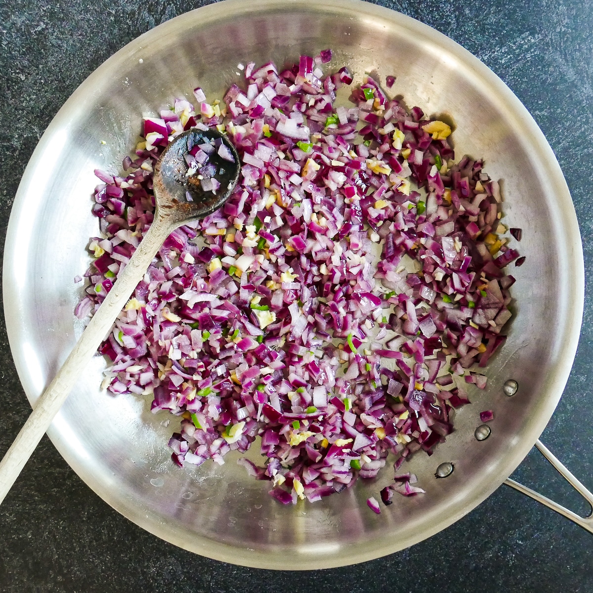 Ginger, garlic, chile, and salt added to cooked onion mixture.