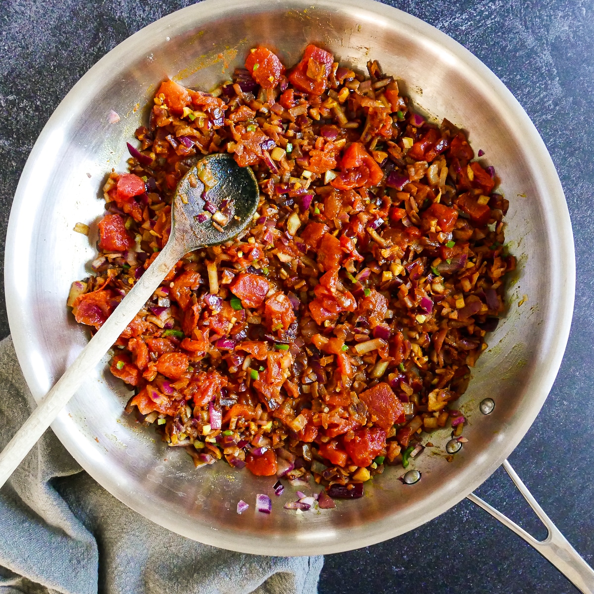 Berbere seasoning and tomatoes added to onion mixture.