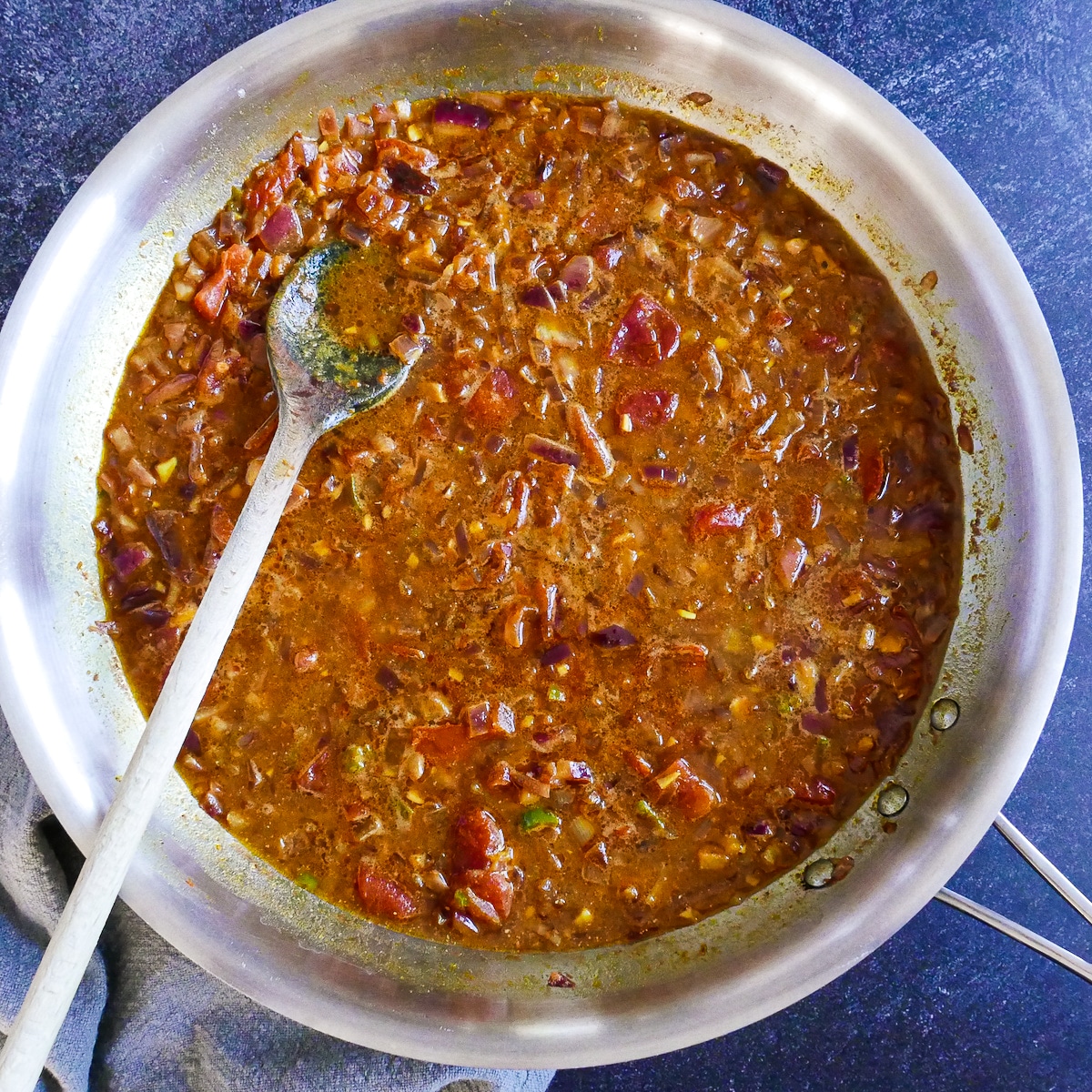 Coconut milk and vegetable broth added to skillet.