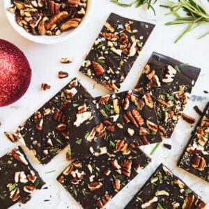 Chocolate pecan bark cut into squares and arranged on a table.