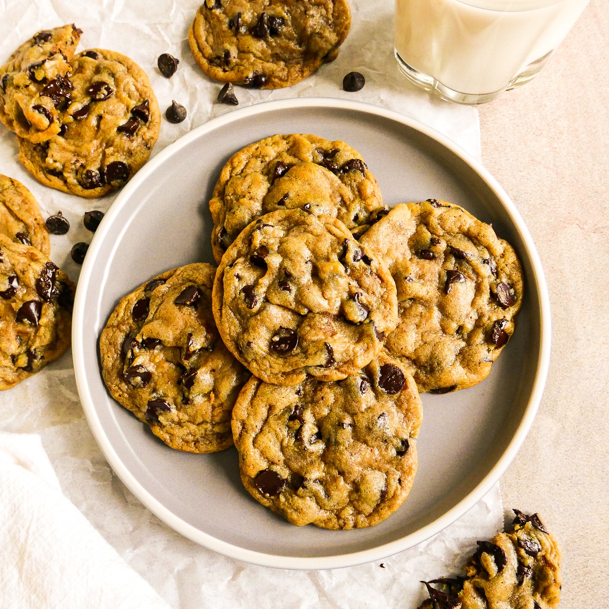 plate of brown butter chocolate chip cookies with a glass of milk. 