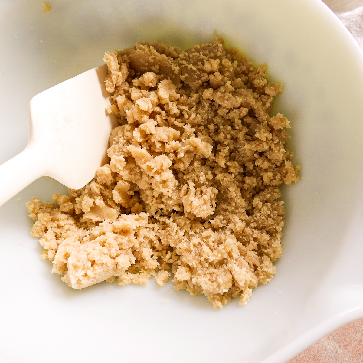 cookie dough in a bowl with a rubber spatula.