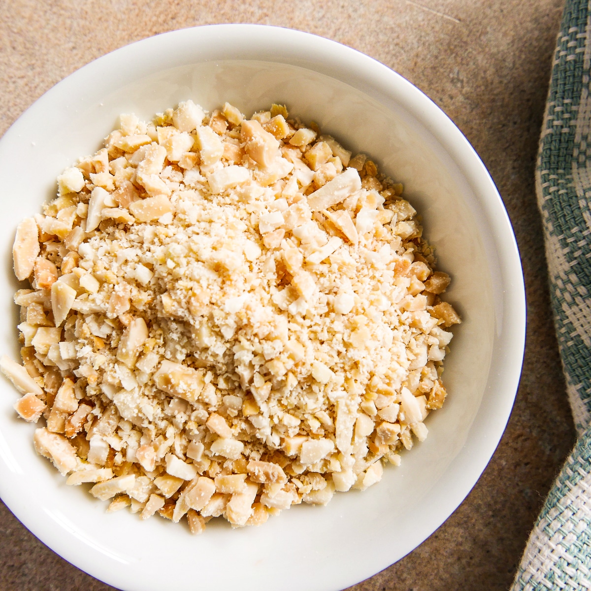 small white bowl of crushed slivered almonds.