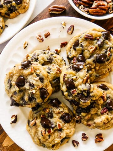 plate of chewy pecan chocolate cookies with chopped pecans.