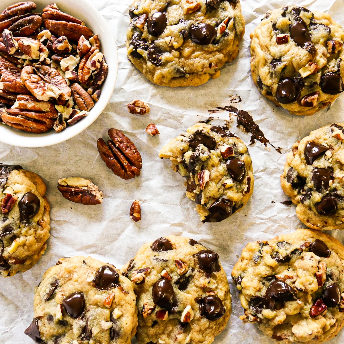 pecan-cookies-on-parchment.jpg Crisp and chewy chocolate pecan cookies arranged on parchment paper.