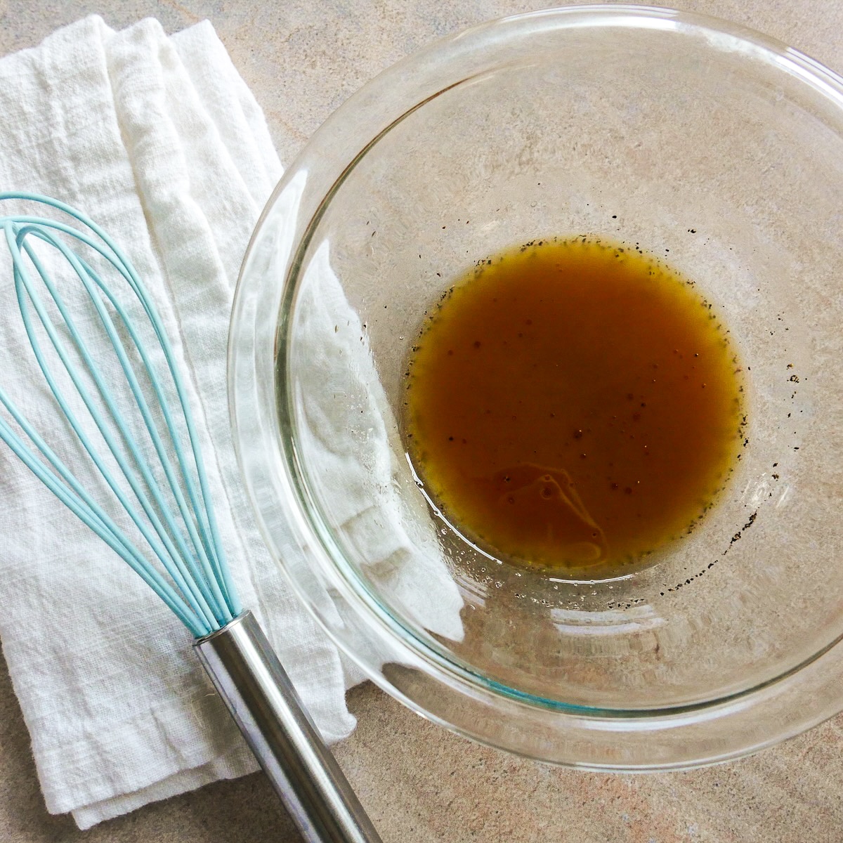 Red wine vinaigrette whisked together in a small bowl.