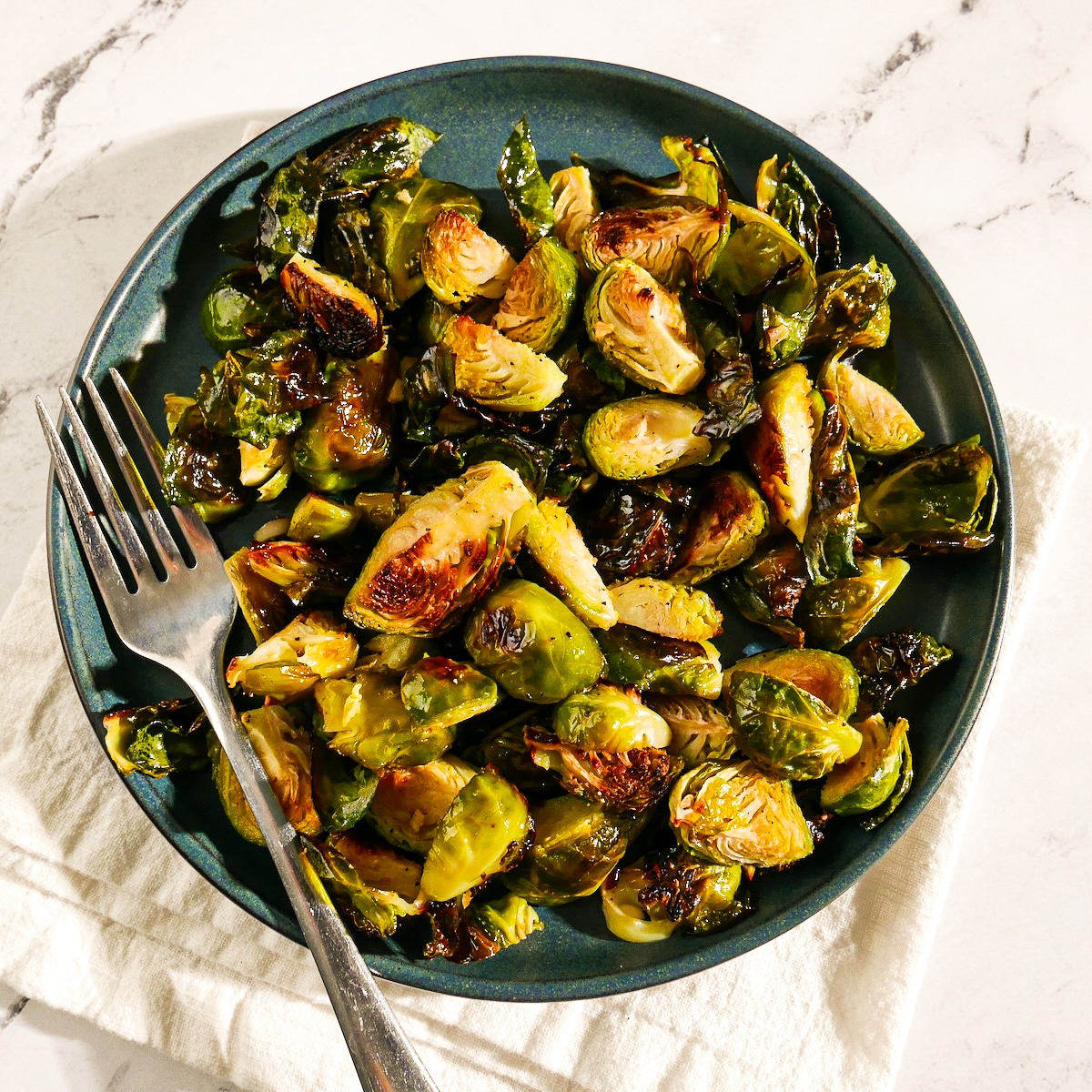 Crispy Brussels sprouts served on a plate.