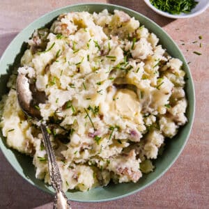 Creamy mashed potatoes garnished with fresh chives.