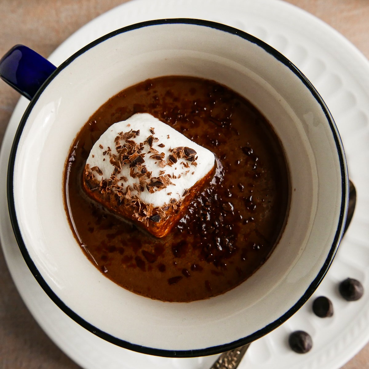 marshmallow-in-hot-chocolate.jpg Large marshmallow floating in a cup of vegan oat milk hot chocolate.