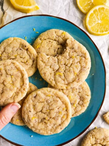 Chewy vegan lemon cookies arranged on a blue plate.