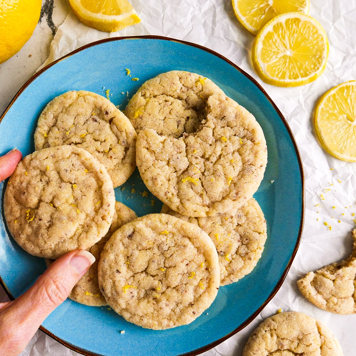 Chewy vegan lemon cookies arranged on a blue plate. 