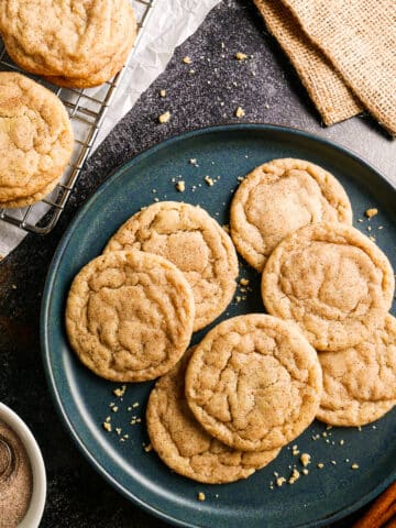 chewy brown butter snickerdoodles arranged on a blue plate.