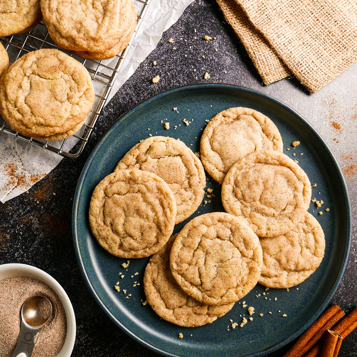 chewy brown butter snickerdoodles arranged on a blue plate.