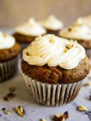 Moist carrot cupcakes frosted with cream cheese frosting.