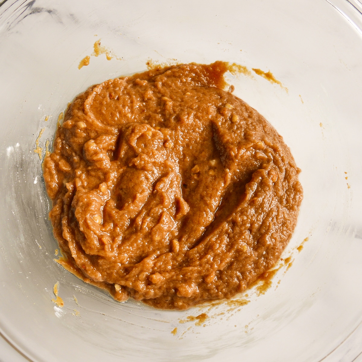 Pie ingredients mixed together with an electric mixer in a bowl.