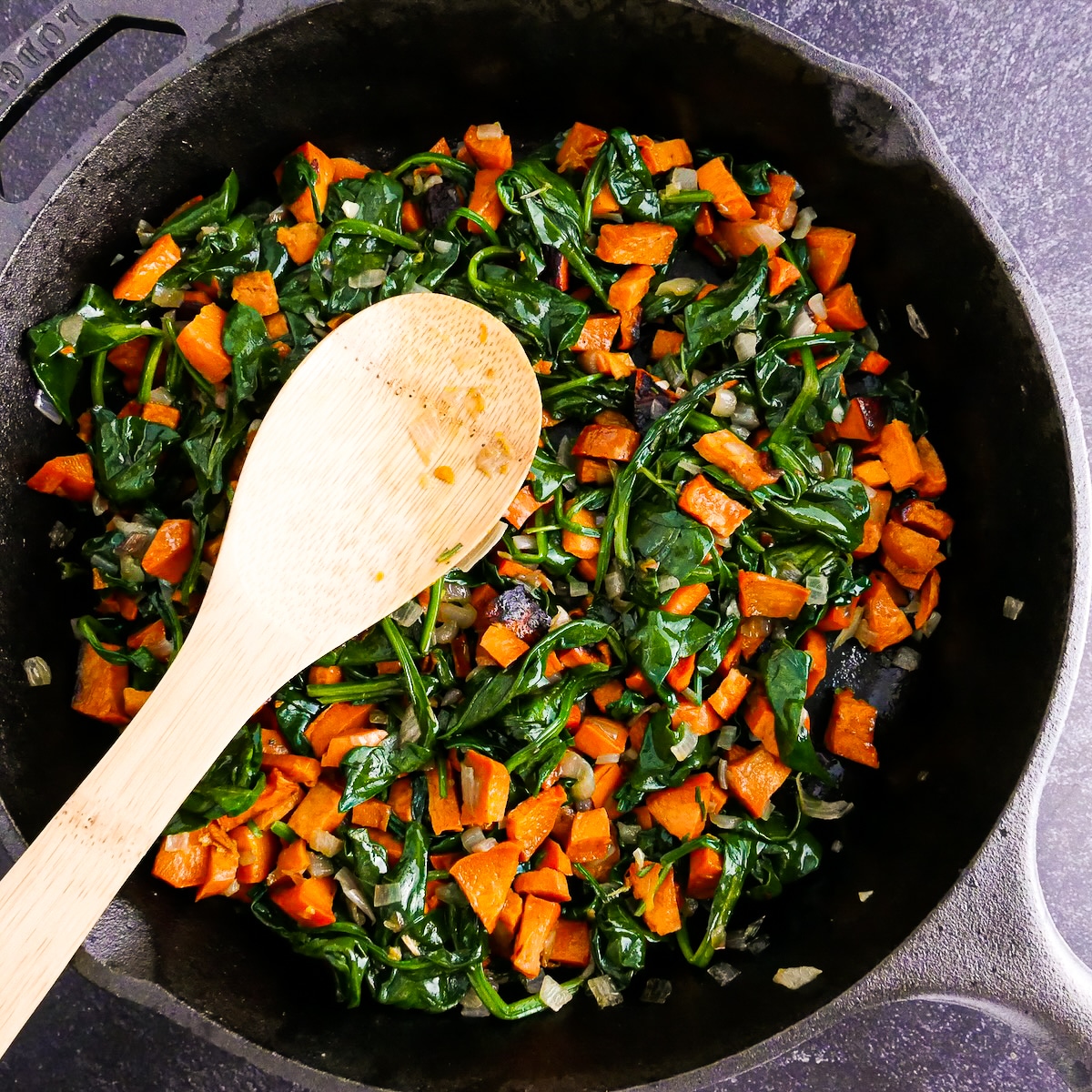 Roasted sweet potatoes added to cooked spinach mixture.