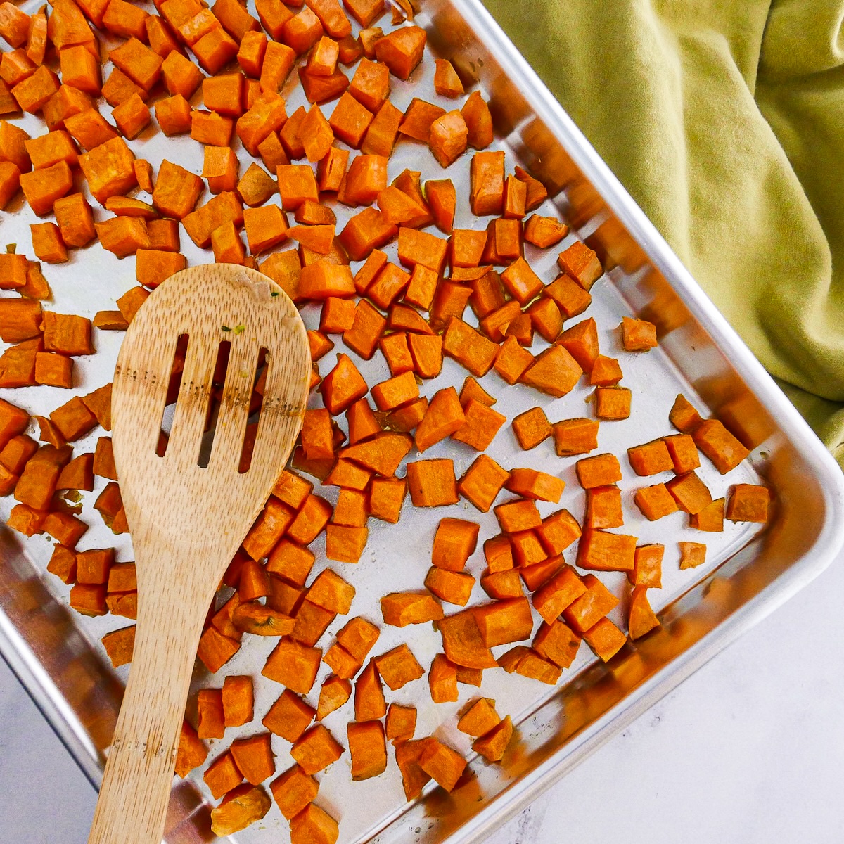 Roasted sweet potatoes on a baking sheet.