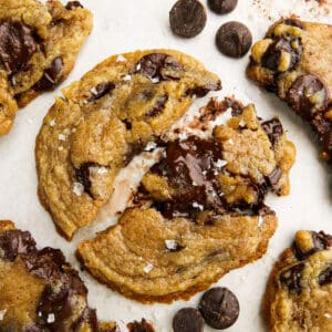 Chewy and crisp brown butter chocolate chip cookies arranged on parchment paper.