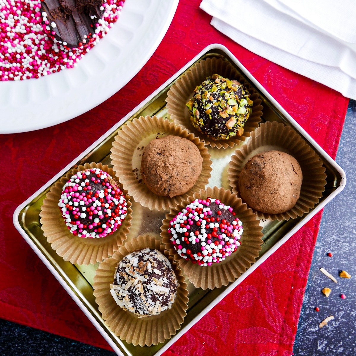 Box of homemade vegan truffles coated in different toppings.