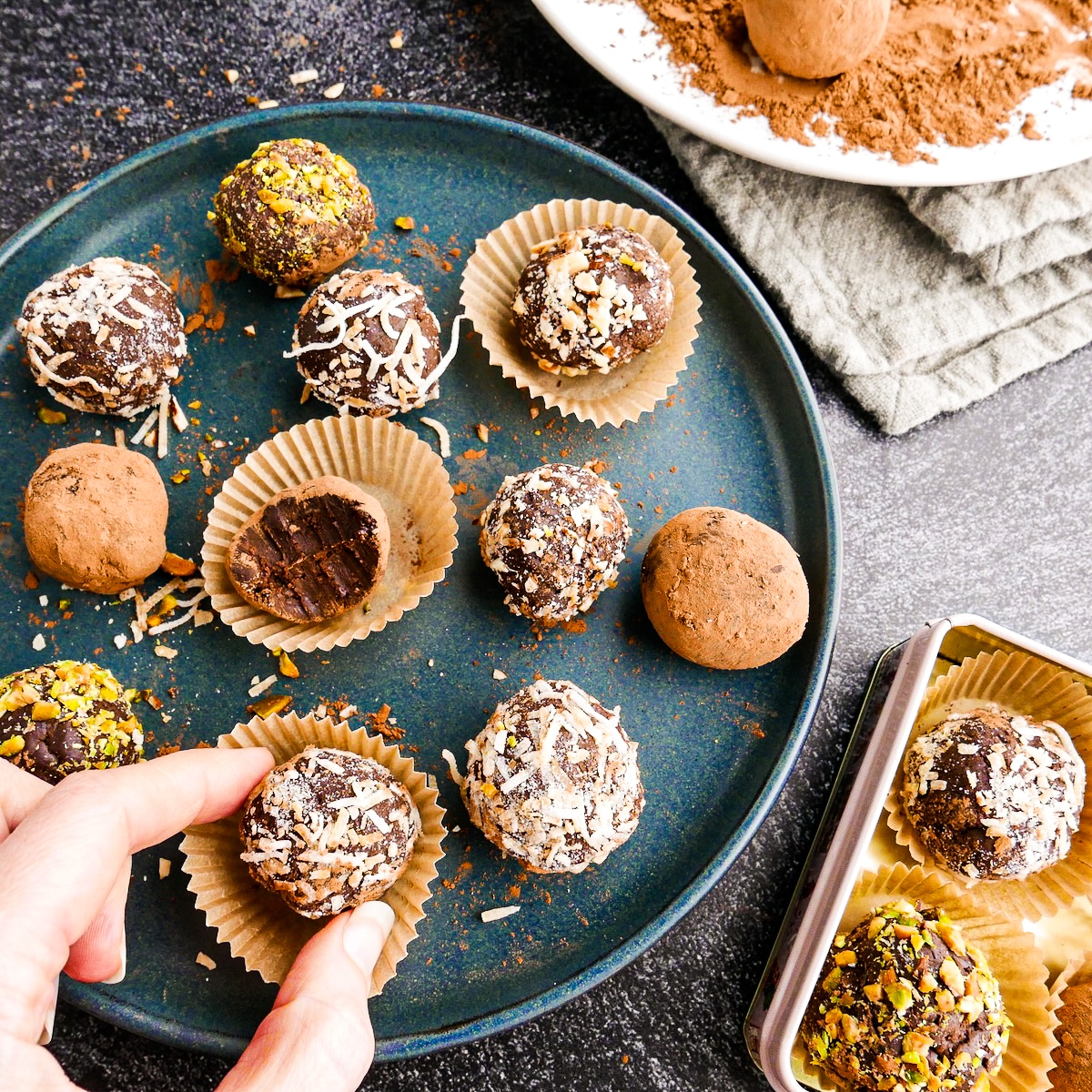 A plate of chocolate truffles on a table.