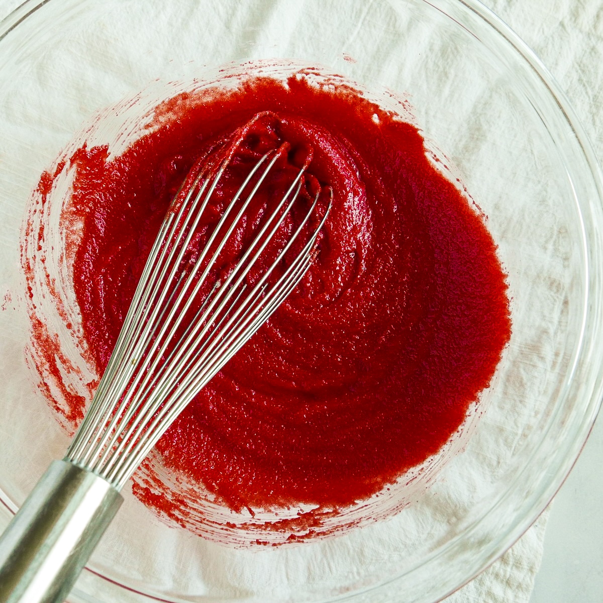 Red food coloring, vanilla, and vinegar mixed into brownie batter.