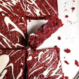 Fudgy red velvet brownies covered in a cream cheese glaze.