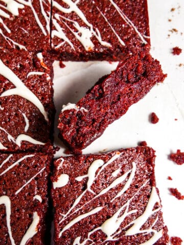 Fudgy red velvet brownies covered in a cream cheese glaze.